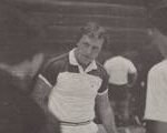 Black and White photo of John Britton at a competition wearing a polo shirt